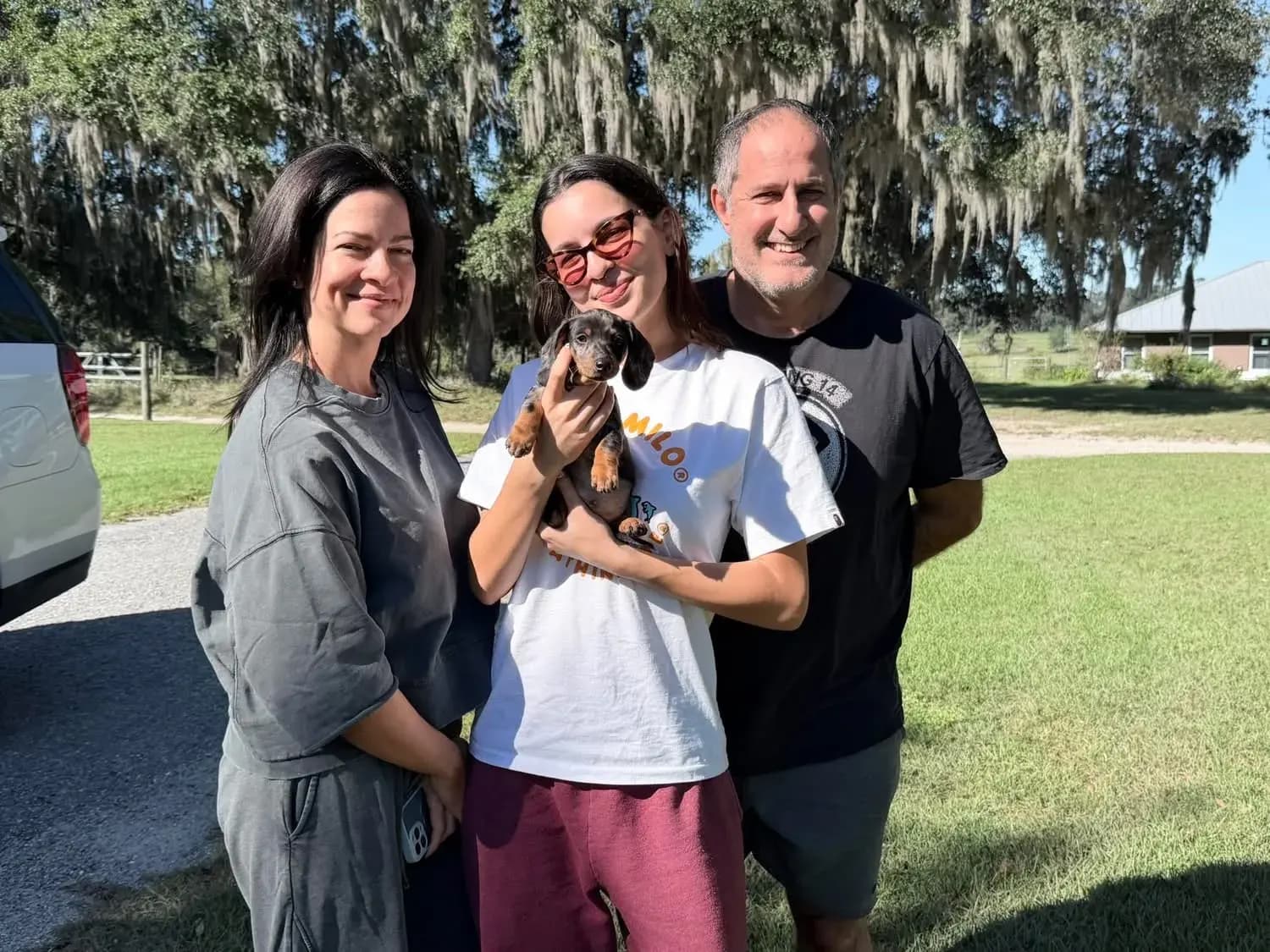 A family picking up their Miniature Dachshund puppy at Irish Rose Acres